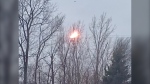 Powerful wind gusts in London, Ont. Dec. 3, 2022 knocked down power lines and caused outages across the city. A dangling power line off Darlene Crescent made contact with other lines several times, causing fiery explosions. (Sean Irvine/CTV News London) 