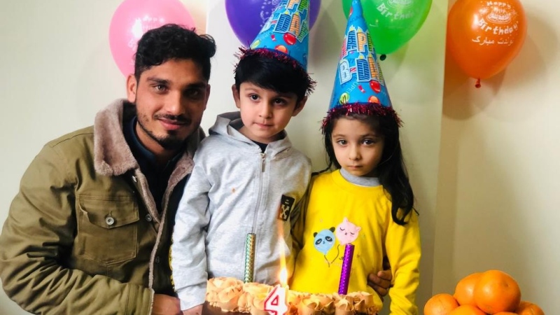 Irfanullah Noori, poses with his twin children on their 4th birthday in Kabul. The 28 year old Afghan refugee and his family were granted asylum in Canada this past October, more than a year after the Taliban took over Afghanistan. (Supplied)