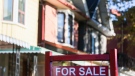 A real estate sign is displayed in front of a house in the Riverdale area of Toronto on Wednesday, September 29, 2021. THE CANADIAN PRESS/Evan Buhle