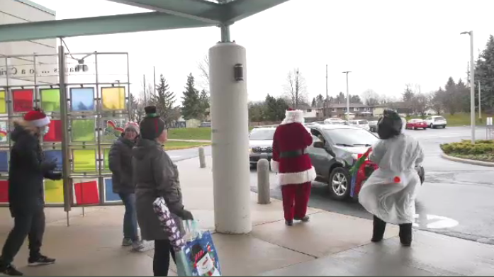 Santa and his helpers greeting children in cars for the December to Remember drive-thru event hosted by KidsAbility on Dec.3.
