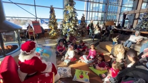 Kids listen to Mrs. Claus read them a story at the Winter Wonderland Saturday at ATCO Park in Calgary