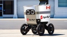 An autonomous robot delivering a pizza from Pizza Hut is shown in Vancouver in this undated handout photo. Pizza Hut used Serve Robotics' autonomous robots to delivery pizzas in Vancouver in September. The autonomous robots resemble a cooler on four wheels with eyelike lights. They travelled by sidewalk to customers, who punched unique codes into a keypad to open their lids and reveal their food. (THE CANADIAN PRESS/HO-Pizza Hut and Serve Robotics)