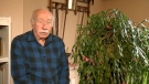 Art Eisner sits in his home next to a 100-year-old Christmas cactus that's been cared for by the Eisner family for generations.