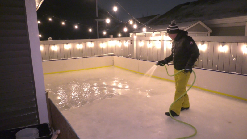 Jeff Nash, Griesbach resident, floods an outdoor rink in his backyard in December 2022. 