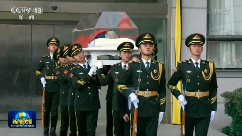 Honour guards carry the remains of former president Jiang Zemin at a military hospital in Beijing, China, on Dec. 5, 2022. (CCTV via AP) 