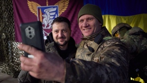 A Ukrainian soldier takes a selfie with President Volodymyr Zelenskyy, left, during his visit to Slavyansk, Donbas region, Ukraine, on Dec. 6, 2022. (Ukrainian Presidential Press Office via AP) 