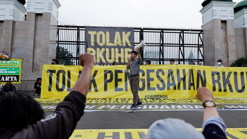 Indonesian lawmakers unanimously passed a sweeping new criminal code that criminalizes sex outside marriage, as part of a tranche of changes that critics say threaten human rights and freedoms, and pictured, an activist in Jakarta, Indonesia on December 5. (Willy Kurniawan/Reuters)

