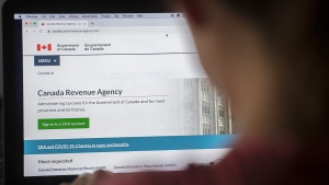 A person looks at a Canada Revenue Agency homepage in Montreal, Sunday, August 16, 2020. THE CANADIAN PRESS/Graham Hughes