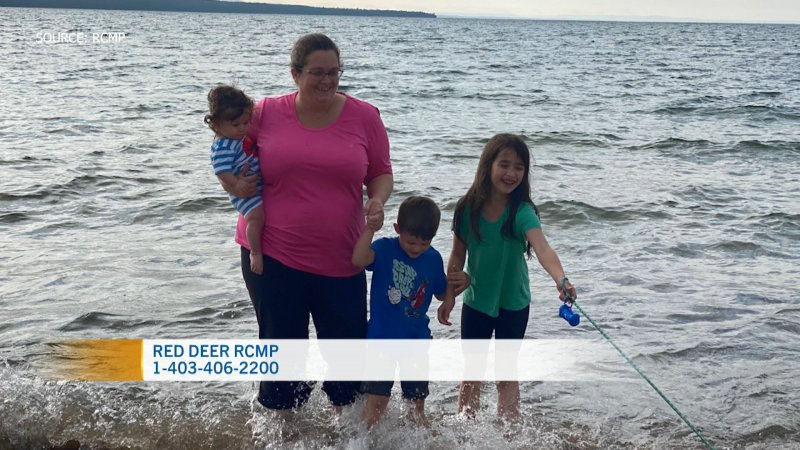 In this undated photograph provided by police, Susan French, in pink, stands with her children Deckard, left, Ryker, middle-right, and Emma, right, on a beach. Red Deer RCMP issued a missing persons notice on Dec. 6, 2022. (Source: RCMP)