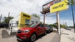 This May 23, 2020, photo shows rental vehicles parked outside a closed Hertz car rental office in south Denver. (AP Photo/David Zalubowski, file)