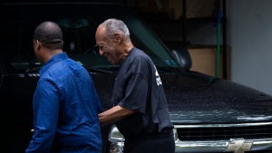 Bill Cosby leaves his home alongside spokesperson Andrew Wyatt Thursday, July 1, 2021 in Elkins Park, Pa. (Joe Lamberti/Camden Courier-Post via AP)