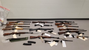 Nearly two dozen guns were seized from a Cambridge residence. (WRPS)