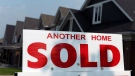 A for sale sign displays a sold home in a development in Ottawa on July 6, 2015. THE CANADIAN PRESS/Sean Kilpatrick