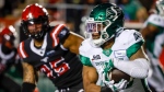 Saskatchewan Roughriders' Jamal Morrow, right, runs the ball as Calgary Stampeders' Stefen Banks closes in during first half CFL football action in Calgary, Saturday, Oct. 29, 2022.THE CANADIAN PRESS/Jeff McIntosh
