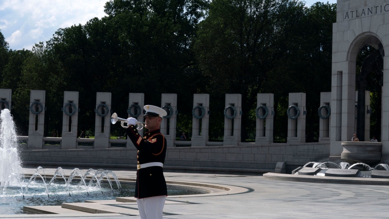 A Marine sounds his trumpet during the memorial for Hershel W. "Woody" Williams at the World War II Memorial Thursday, July 14, 2022 in Washington. Williams, the last remaining Medal of Honor recipient from World War II, died at age 98. (AP Photo/Jose Luis Magana)