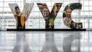 Faces of native Canadians appear on a 'YYC' sign at Calgary International Airport in Calgary, Alta., Monday, Oct. 10, 2022. (THE CANADIAN PRESS/Jeff McIntosh)