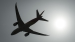 A plane is silhouetted as it takes off from Vancouver International Airport in Richmond, B.C., May 13, 2019. THE CANADIAN PRESS/Jonathan Hayward