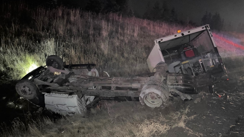 A commercial truck rolls and crashes along Highway 400 in Bradford, Ont., on Tues., Dec. 6, 2022. (OPP/Twitter)