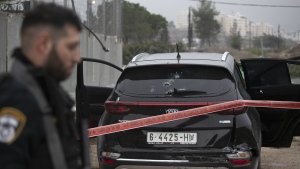 Israeli police cordoned off the car belonging to a Palestinian man that rammed into an Israeli soldier, Tuesday, Nov. 29, 2022. (AP Photo/Oren Ben Hakoon)