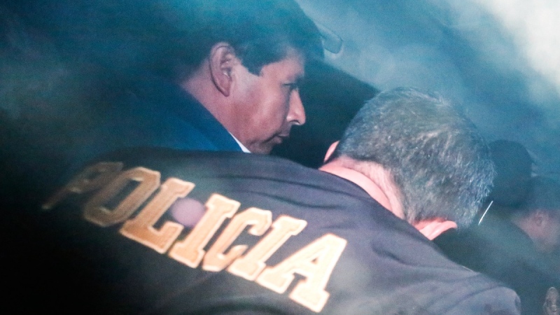 Peru's ousted President Pedro Castillo is escorted by police in Lima, Peru, on Dec. 7, 2022. (Renato Pajuelo / AP) 