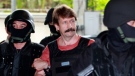 Viktor Bout, centre, is led to court by armed Thai police in Bangkok, Thailand, on Oct. 5, 2010. (Apichart Weerawong /AP)