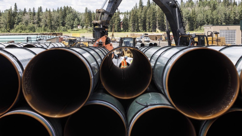 Pipe for the Trans Mountain pipeline is unloaded in Edson, Alta. on June 18, 2019. The Canada Energy Regulator has issued financial penalties against Trans Mountain Pipeline Corp. related to the 2020 death of a worker. (THE CANADIAN PRESS/Jason Franson)