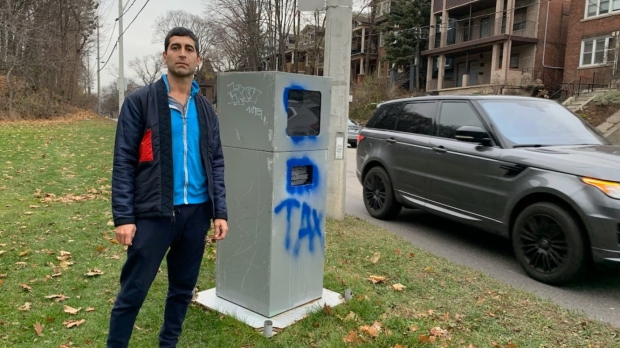 Parkside Drive resident Faraz Gholizadeh stands next to the automated speed enforcement device on Parkside Drive, just south of Algonquin Avenue. For the last six months, the photo radar camera on Parkside Drive has issued the most tickets to speeding drivers in the city. (Supplied photo)
