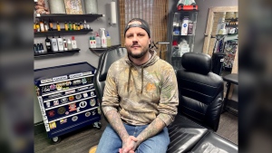 Jon Champagne, a tattoo artist in Simcoe, Ont., is seen in his studio on Dec. 8, 2022. Champagne is offering free coverups of hate symbols. (Sean Irvine/CTV News London)