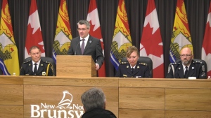 Woodstock Police Chief Gary Forward, left, Public Safety Minister Kris Austin, RCMP Assistant Commissioner DeAnna Hill, and Jacques Babin, chief of inspections and enforcement at the New Brunswick Department of Justice and Public Safety appear at a news conference on Dec. 8, 2022. (Nick Moore/CTV) 
