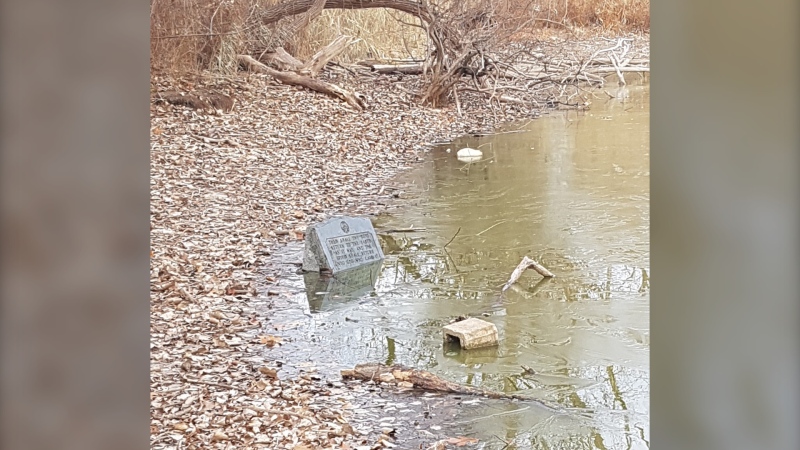 The Masonic Memorial monument is seen dumped in a pond at Malden Park in Windsor, Ont. in an act of vandalism. (Source: David Woodman)