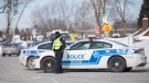 FILE: Police are shown on the scene in the Montreal suburb of Dollard-Des Ormeaux in Montreal, Saturday, February 13, 2021. THE CANADIAN PRESS/Graham Hughes
