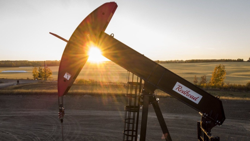 A pumpjack draws out oil and gas from a well head as the sun sets near Calgary, Alta., Sunday, Oct. 9, 2022. Crescent Point Energy Corp. says it has signed an agreement with Paramount Resources Ltd. to acquire additional Kaybob Duvernay assets for $375 million. (THE CANADIAN PRESS/Jeff McIntosh)