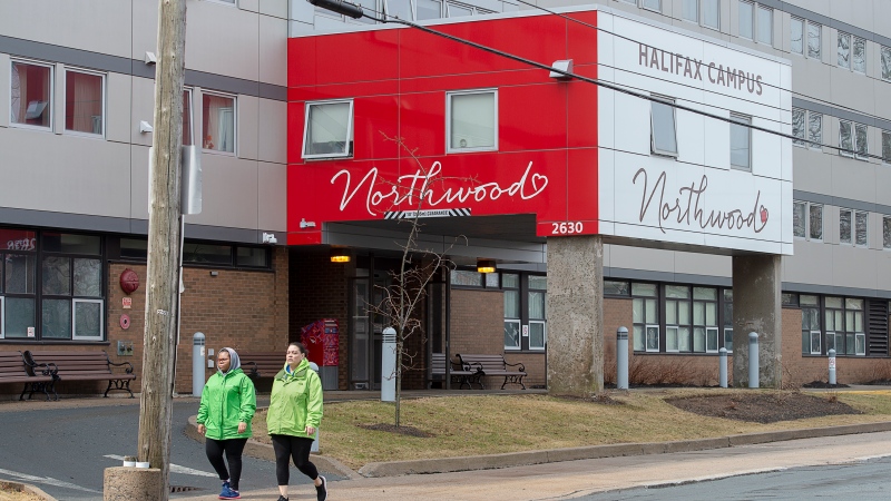 Two women walk past Northwood Manor in Halifax on Monday, April 13, 2020. The facility, one of the largest nursing homes in Atlantic Canada  (THE CANADIAN PRESS/Andrew Vaughan)