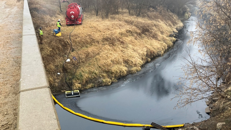 A remediation company deploys a boom on the surface of an oil spill after a Keystone pipeline ruptured at Mill Creek in Washington County, Kansas, on Dec. 8, 2022. (Kyle Bauer/KCLY/KFRM Radio via AP)