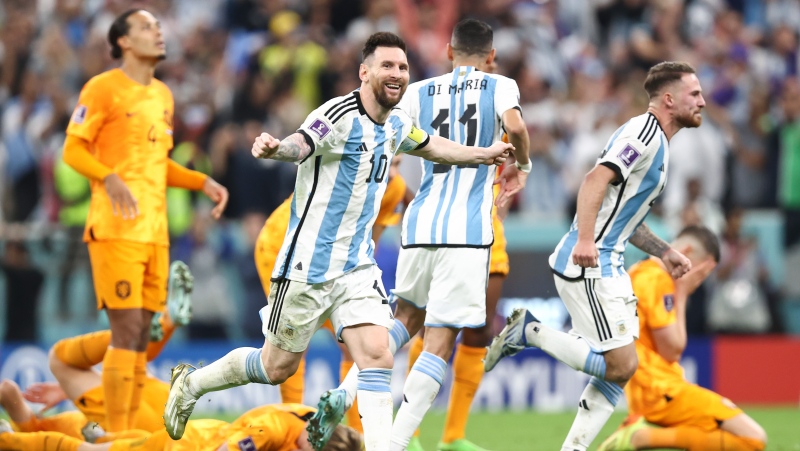 Lionel Messi of Argentina celebrates after Lautro Martinez of Argentina scored the winning penalty in the penalty shoot out during the FIFA World Cup Qatar 2022 quarter final match between Netherlands and Argentina at Lusail Stadium on Dec. 9, 2022 in Lusail City, Qatar. (Photo by James Williamson - AMA/Getty Images)