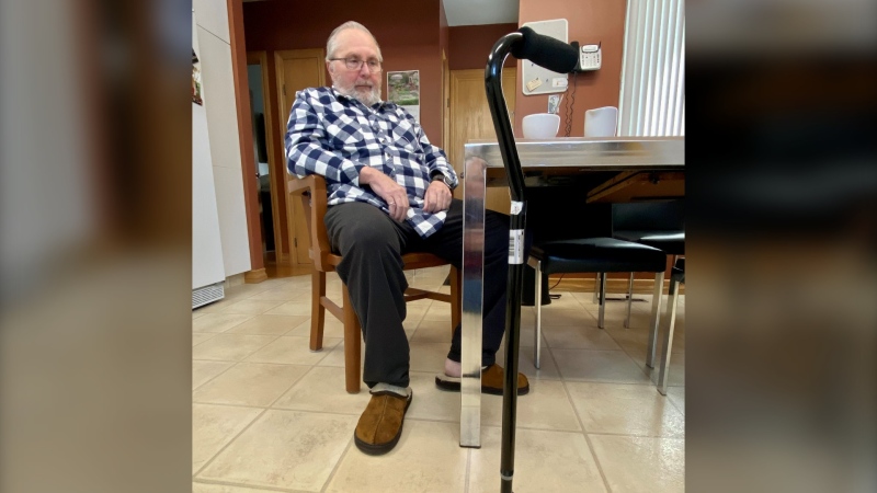 John Shivak sits in the kitchen of his Regina home. He has suffered with Stiff-Person Syndrome for decades. (Gareth Dillistone / CTV News) 
