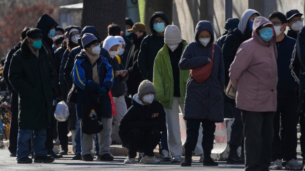 Residents line up to enter the fever clinic of a hospital in Beijing, Sunday, Dec. 11, 2022. (AP Photo/Andy Wong)
