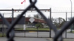 William Head Institution is shown through a security fence in Victoria, B.C., on Wednesday, Feb. 27, 2008. (THE CANADIAN PRESS/Adrian Lam)