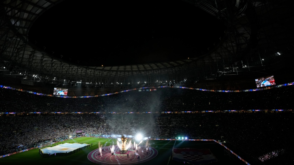 Fireworks go off around a mock World Cup trophy