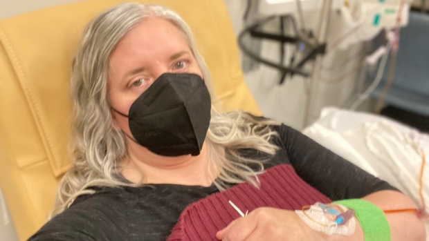 Amy Watson, of Portland, Ore., seen during an iron infusion in December 2022, says she has 'never had any kind of recovery' from COVID-19.  (Amy Watson via AP) 