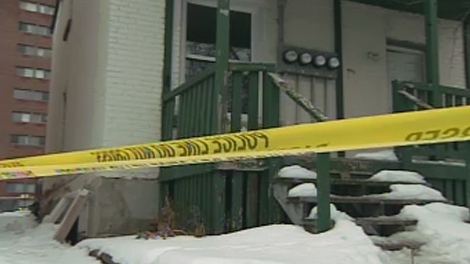 Police tape blocks off a home on Cambridge Street, where two bodies were found, Saturday, Jan. 16, 2010.
