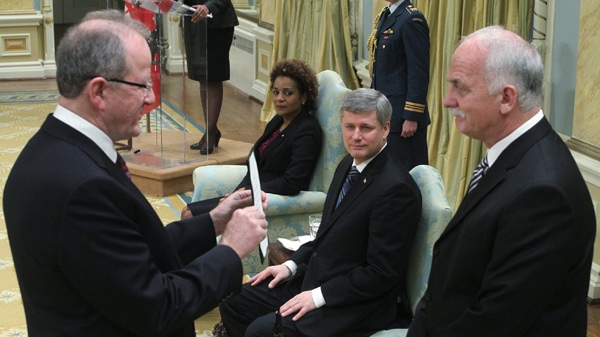 Chief of the Privy Council Wayne Wouters, left, swears in Vic Toews (right) as Minister of Public Safety as Prime Minister Stephen Harper and Governor General Michaelle Jean look on at Rideau Hall in Ottawa on Tuesday, Jan. 19, 2010. (Fred Chartrand / THE CANADIAN PRESS)