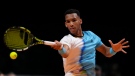 Canada's Felix Auger-Aliassime of Kites, returns the ball to Germany's Alexander Zverev of Hawks, during the final day of the World Tennis League at Coca-Cola Arena, in Dubai, United Arab Emirates, Saturday, Dec. 24, 2022. (AP Photo/Kamran Jebreili)