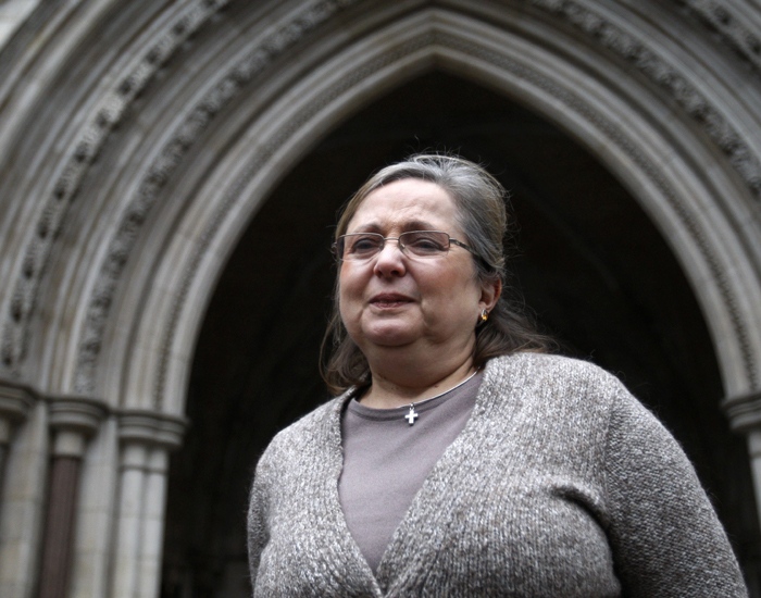 Christian British Airways check-in employee Nadia Eweida arrives at the Royal Courts of Justice to fight a ruling that she was not a victim of religious discrimination by British Airways, London, Tuesday, Jan. 19, 2010. (AP Photo/Sang Tan)