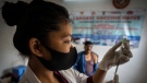 A nurse prepares to administer vaccine for COVID-19 at a private vaccination center in Gauhati, India, April 10, 2022. (AP Photo/Anupam Nath, File)