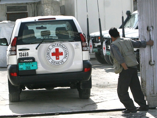 An Afghan closes the gate as a International Red Cross vehicle enters their office in Kabul, Afghanistan on Thursday, Sept. 27, 2007. (AP / Rafiq Maqbool)