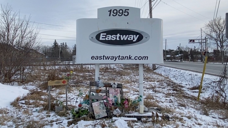 Sign and flower memorial: A memorial sits at the base of the Eastway Tank sign on Merivale Road. (Katie Griffin/CTV Ottawa)