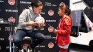 Canadian soccer star Christine Sinclair autographs a fan's ball at a World Cup watch party in Toronto on Wednesday, Nov. 23, 2022. THE CANADIAN PRESS/Arlyn McAdorey 