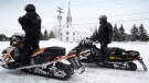 American tourists stop in front of the parish church, as a major snowmobile trail passes through La Motte, Que. THE CANADIAN PRESS/Paul Chiasson