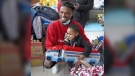 Pittsburgh NCAA college football defensive back Damar Hamlin poses for a photo with Bryce Williams, 3, of McKees Rocks, Pa., after the youngster picked out a toy during Hamlin's Chasing M's Foundation community toy drive at Kelly and Nina's Daycare Center, Tuesday, Dec. 22, 2020, in McKees Rocks, Pa. Buffalo Bills safety Damar Hamlin plans to support young people through education and sports with the $8.6 million in GoFundMe donations that unexpectedly poured into his toy drive fundraiser after he suffered a cardiac arrest in the middle of a game last week. (Matt Freed/Pittsburgh Post-Gazette via AP, File)